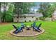 A backyard fire pit with comfortable seating surrounded by lush landscaping at 679 Forest Ridge Se Dr, Marietta, GA 30067