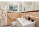 Classic bathroom featuring vintage tile, a shower with floral curtain, and ample counter space at 679 Forest Ridge Se Dr, Marietta, GA 30067