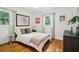 Comfortable bedroom featuring hardwood floors, two windows, and neutral decor at 679 Forest Ridge Se Dr, Marietta, GA 30067