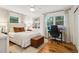 Inviting bedroom featuring a workstation, large window, neutral tones, and wood floors at 679 Forest Ridge Se Dr, Marietta, GA 30067