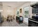 Bright dining area with pendant lighting, white paneled walls, and a stylish tile floor adjacent to the kitchen at 679 Forest Ridge Se Dr, Marietta, GA 30067