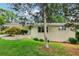 Quaint single-story home with brick exterior, manicured lawn, and a covered parking area at 679 Forest Ridge Se Dr, Marietta, GA 30067