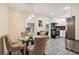 Eat-in kitchen with patterned tile floor, stainless steel appliances, and a modern light fixture at 679 Forest Ridge Se Dr, Marietta, GA 30067