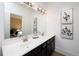 Bathroom vanity with double sinks, modern faucets, and elegant artwork enhances the space at 1600 Driggs Nw Dr # 162, Atlanta, GA 30318