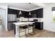 Open-concept kitchen featuring stainless steel appliances, dark cabinetry, and a white island with bar stool seating at 1600 Driggs Nw Dr # 162, Atlanta, GA 30318