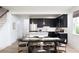 Modern kitchen featuring stainless steel appliances, black cabinetry, and an adjacent dining area perfect for entertaining at 1600 Driggs Nw Dr # 162, Atlanta, GA 30318