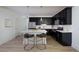 Sleek modern kitchen featuring black cabinets, stainless steel appliances, and a bright white island with seating at 1600 Driggs Nw Dr # 162, Atlanta, GA 30318