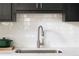 Contemporary kitchen sink with sleek faucet, white countertops, modern backsplash, and ample counter space at 1600 Driggs Nw Dr # 162, Atlanta, GA 30318