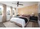Comfortable main bedroom with wood accent wall, large windows, stylish rug, and modern decor at 1600 Driggs Nw Dr # 162, Atlanta, GA 30318