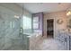 Luxurious bathroom featuring a glass shower, soaking tub, marble accents, and -and- granite vanity at 1867 Sterling Chase, Buford, GA 30518