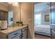 Stylish bathroom featuring granite countertops, modern fixtures, and an open doorway leading to a bedroom at 1867 Sterling Chase, Buford, GA 30518