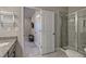 Stylish bathroom featuring a glass-enclosed shower, toilet and view into the bedroom at 1867 Sterling Chase, Buford, GA 30518