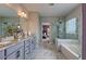 Spacious bathroom featuring a glass shower, soaking tub, double sink, and large mirror for a modern touch at 1867 Sterling Chase, Buford, GA 30518