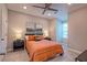 Comfortable bedroom features neutral walls, ceiling fan, and an inviting orange quilted bed set at 1867 Sterling Chase, Buford, GA 30518