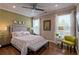 Serene bedroom featuring a comfortable bed, hardwood floors, and ample natural light from the windows at 1867 Sterling Chase, Buford, GA 30518