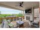 Enjoy this covered deck, complete with a ceiling fan, TV, fireplace, and comfortable seating for relaxing outdoors at 1867 Sterling Chase, Buford, GA 30518