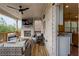 Relax on this covered deck with a fireplace, TV, ceiling fan, and comfortable seating, offering great views of the backyard at 1867 Sterling Chase, Buford, GA 30518