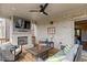 Comfortable covered deck features a brick fireplace with TV, ceiling fan, and cozy seating, perfect for outdoor enjoyment at 1867 Sterling Chase, Buford, GA 30518
