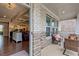 Cozy covered patio with brick accents and a view into the home's living spaces at 1867 Sterling Chase, Buford, GA 30518