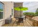 Outdoor deck featuring a dining set, grill, and storage, ideal for enjoying outdoor meals and gatherings at 1867 Sterling Chase, Buford, GA 30518