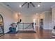 Second-floor space featuring hardwood floors, exercise equipment, and a partial view of the staircase at 1867 Sterling Chase, Buford, GA 30518