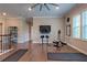 Well-lit exercise room with hardwood floors, ceiling fan, and exercise equipment at 1867 Sterling Chase, Buford, GA 30518