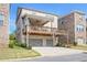 Two-story home with a deck above the garages, overlooking the backyard and a clear blue sky at 1867 Sterling Chase, Buford, GA 30518