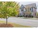 Two-story home with mature tree in the front yard, a covered porch, and manicured landscaping at 1867 Sterling Chase, Buford, GA 30518