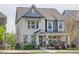 Beautiful two-story home with a covered front porch, light brick, and manicured landscaping at 1867 Sterling Chase, Buford, GA 30518