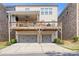 Charming rear exterior features a private covered deck above a two-car garage at 1867 Sterling Chase, Buford, GA 30518