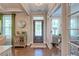 Welcoming foyer showcasing hardwood floors, stylish decor, and a glimpse into other beautifully appointed rooms at 1867 Sterling Chase, Buford, GA 30518