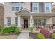 Inviting front porch with brick columns, seating area, and well-maintained landscaping at 1867 Sterling Chase, Buford, GA 30518