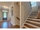 Interior hallway view featuring hardwood floors, entry door, staircase with dark wood and white trim at 1867 Sterling Chase, Buford, GA 30518