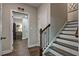 Hallway with a view to the bonus room and stairs with white risers and dark stained hardwood treads at 1867 Sterling Chase, Buford, GA 30518