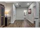 Hallway featuring hardwood floors, neutral paint, and a doorway view to a bathroom at 1867 Sterling Chase, Buford, GA 30518