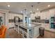 Modern kitchen with granite island, stainless steel appliances, and dark hardwood floors at 1867 Sterling Chase, Buford, GA 30518