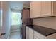 Modern laundry room with stacked washer/dryer, sleek countertops, and ample storage, illuminated by natural light at 1867 Sterling Chase, Buford, GA 30518