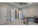 Study with multiple doors, lots of light, ceiling fan, neutral colors and simple desk at 1867 Sterling Chase, Buford, GA 30518