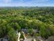 An aerial shot showcases this private community, surrounded by lush trees and the skyline in the distance at 3646 Sope Creek Farm Se, Marietta, GA 30067