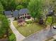 Aerial view of brick home showcasing a well-manicured lawn and long driveway at 3646 Sope Creek Farm Se, Marietta, GA 30067