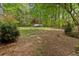 Expansive backyard with lush lawn and mature trees creates a peaceful outdoor space at 3646 Sope Creek Farm Se, Marietta, GA 30067