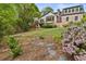 Expansive backyard featuring a multi-level deck, mature trees, flowerbeds, and an expansive grassy area at 3646 Sope Creek Farm Se, Marietta, GA 30067