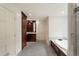 Elegant bathroom featuring a soaking tub, wooden cabinets, and marble floors at 3646 Sope Creek Farm Se, Marietta, GA 30067