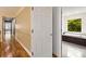 Hallway view leading to a bathroom featuring a soaking tub and large window at 3646 Sope Creek Farm Se, Marietta, GA 30067