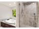 Bathroom features shower and soaking tub with marble surround and large window at 3646 Sope Creek Farm Se, Marietta, GA 30067