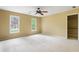 Spacious bedroom with neutral carpet, two windows, ceiling fan and walk-in closet at 3646 Sope Creek Farm Se, Marietta, GA 30067