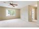 Bright bedroom featuring neutral carpeting, a ceiling fan, and a window offering natural light at 3646 Sope Creek Farm Se, Marietta, GA 30067