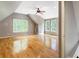 Large bonus room with light gray walls, wood floors, and large windows offering natural light and backyard views at 3646 Sope Creek Farm Se, Marietta, GA 30067