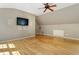 Bonus room featuring hardwood floors, recessed lighting, a ceiling fan, and a wall-mounted television at 3646 Sope Creek Farm Se, Marietta, GA 30067