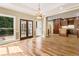 Dining room with hardwood floors, chandelier, double doors to deck, and view into kitchen at 3646 Sope Creek Farm Se, Marietta, GA 30067